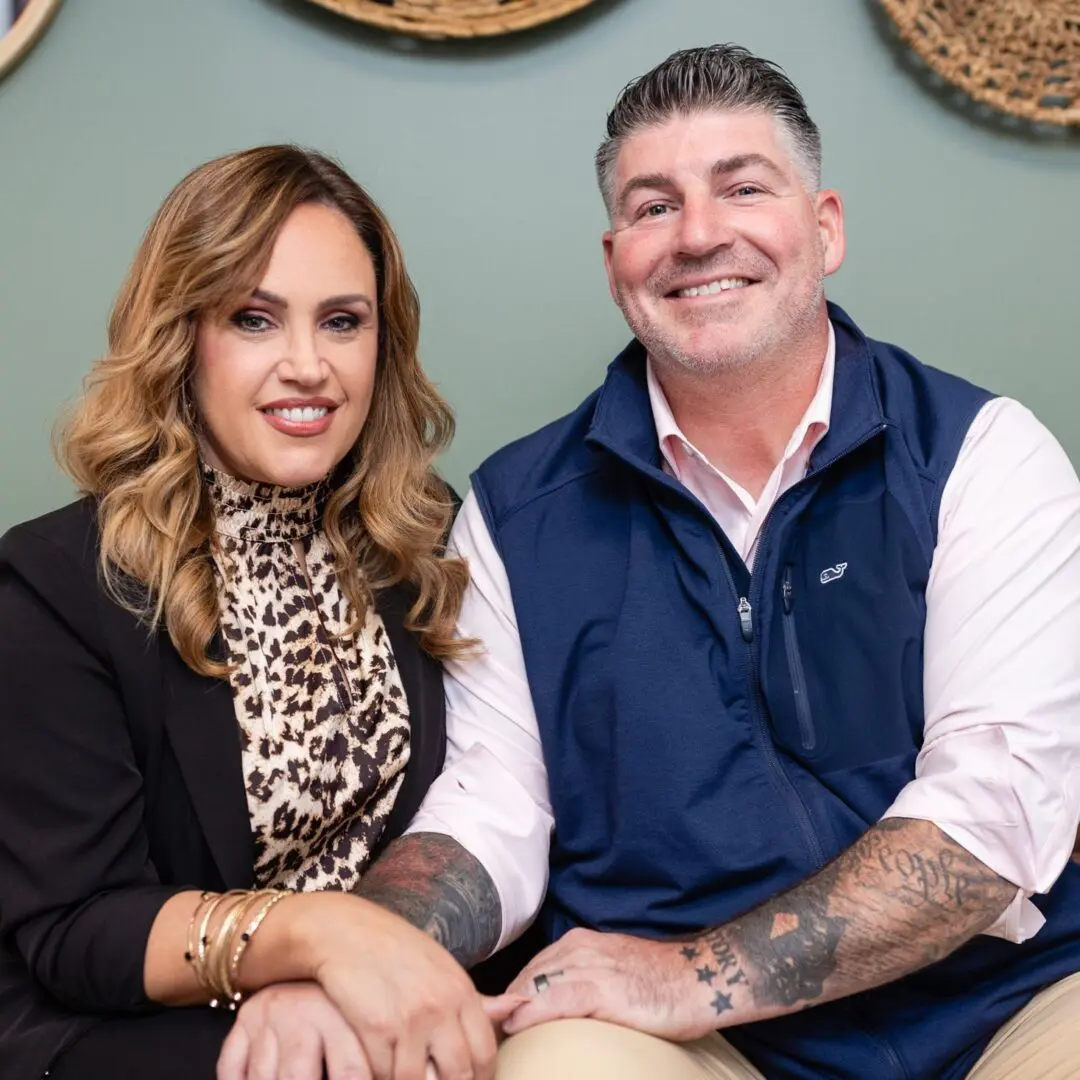 A man and woman sitting on top of a couch.