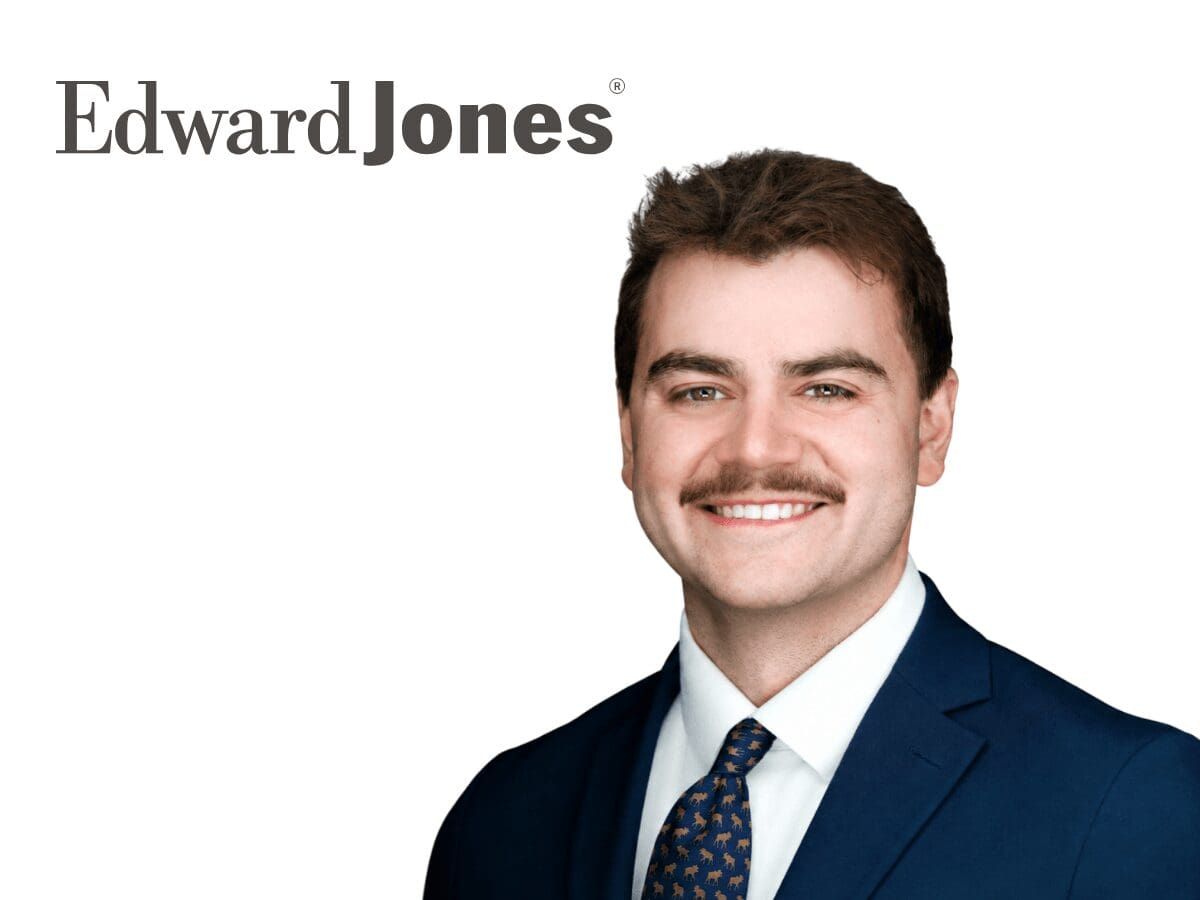 Headshot of Jonah Lemieux in a navy suit beside the dark navy Edward Jones wordmark.